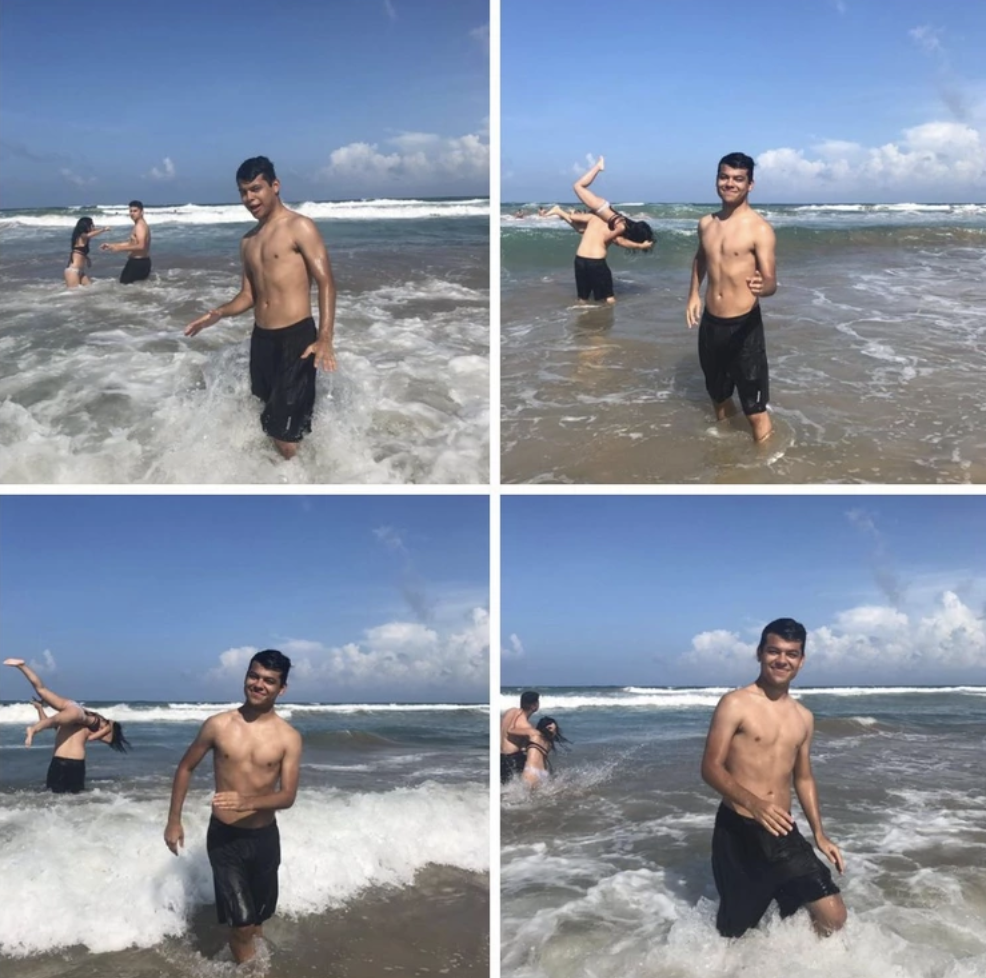 Kid tries to pose for photo in the ocean, and couple behind him is playing while the man tries to flip his girlfriend over his shoulders. 