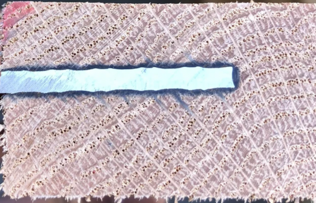 Close-up image of a cut through a nail with a circular saw. 