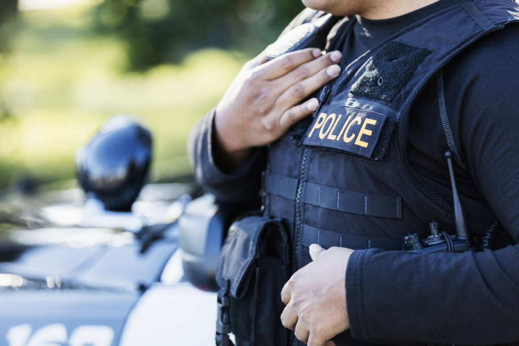 Image of a police officer with a protective vest on,. 