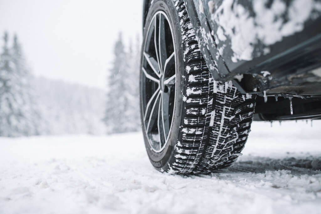 Image of a nice snow tire on a snow-packed road. 