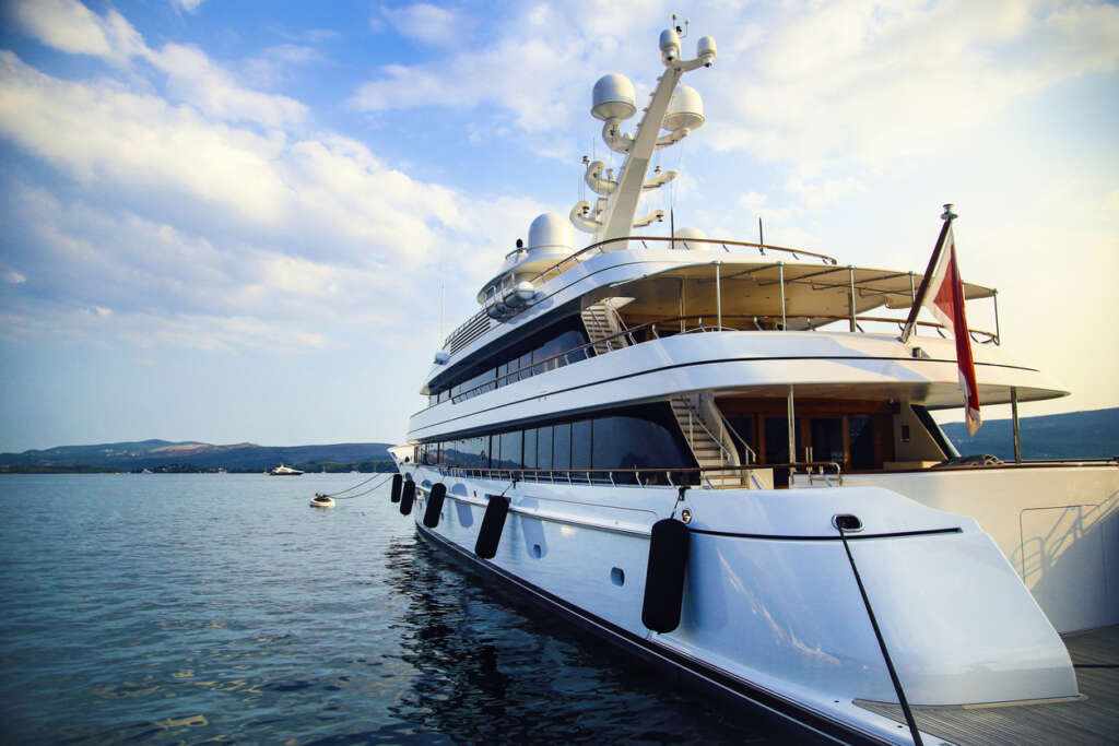 Image of a huge yacht has been stationed in a beautiful marina. 