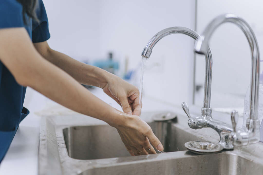 Hospital worker washing their hands. 