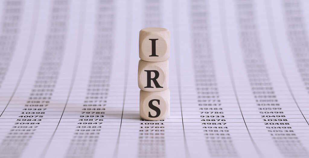 3 dice stacked on top of one another to spell out "IRS."