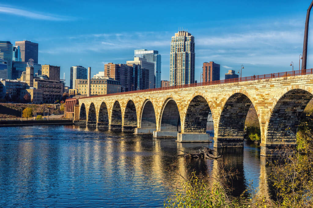 An image of a bridge going to Minneapolis with a sunlit bridge. 