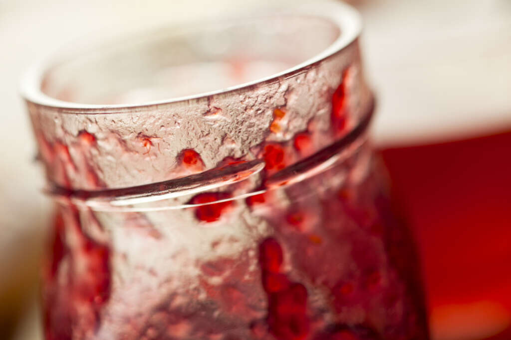 A close-up image of a jar of jam. 