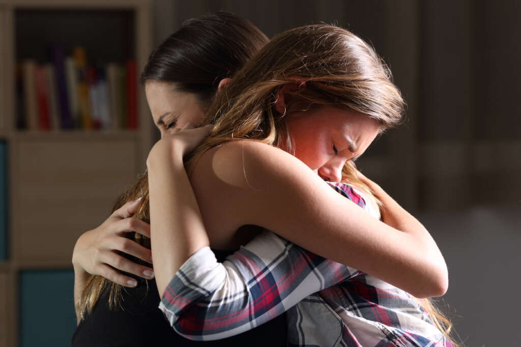 Mom and her daughter having an emotional moment while hugging. 