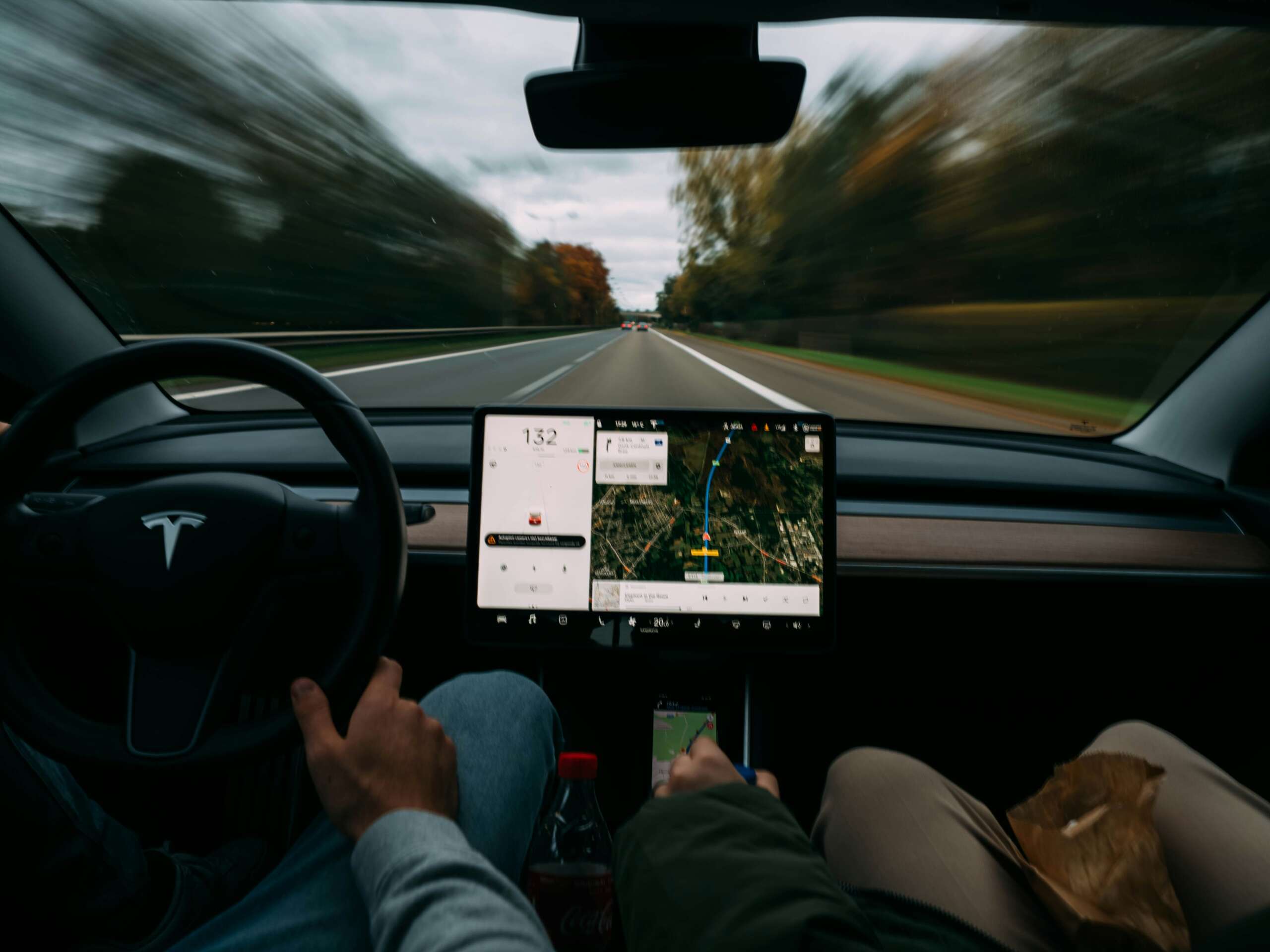 An image of someone using GPS navigation while driving their Tesla.