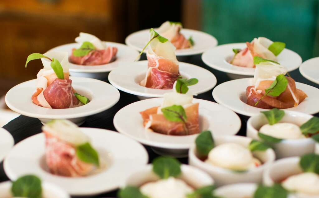 An image of fancily plated small dishes provided by a catering company. 