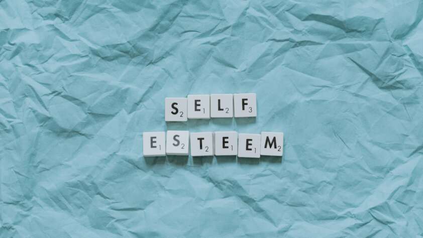 An image of letter blocks spelling out self esteem.