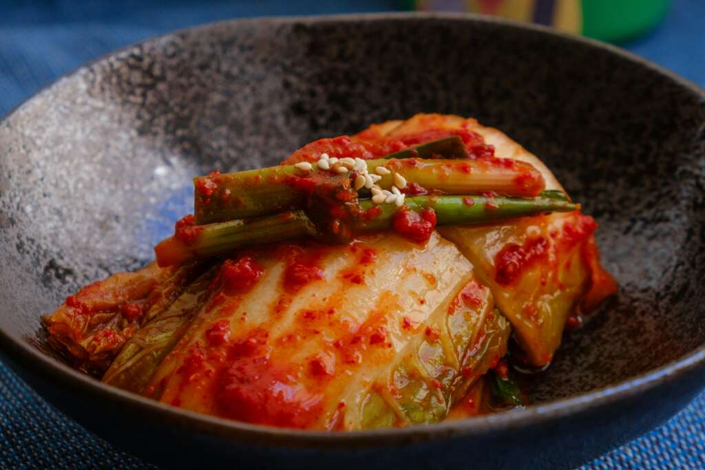 An image of kimchi over chicken. 