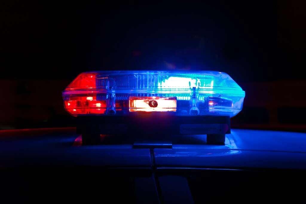 An image of a police car that has its red and blue lights lit up. 