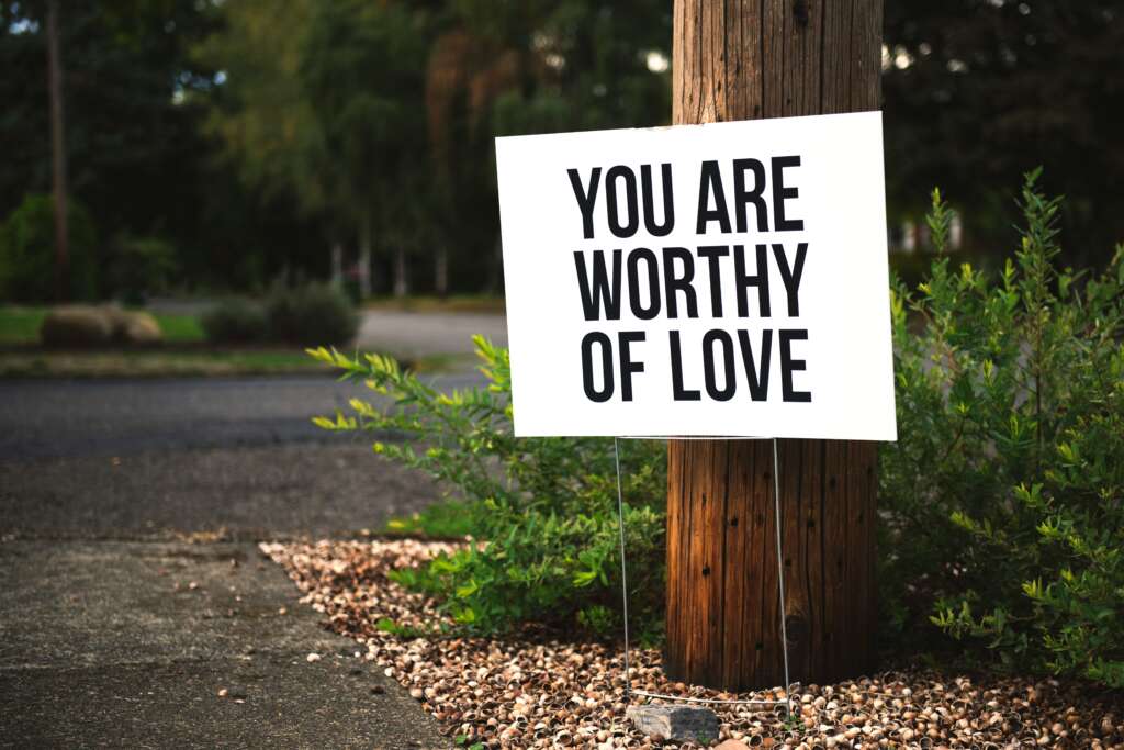 An image of a sign talking about the value of self love. 