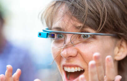 An image of someone using a Google Glass and being very excited about it.
