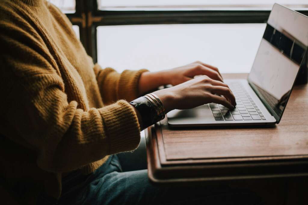 Person typing at their computer. 