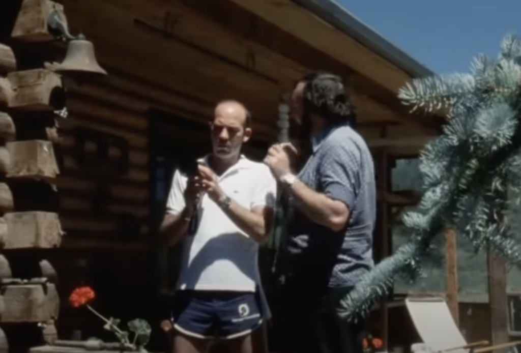 Hunter S. Thompson as a young man, looking at his film camera. 