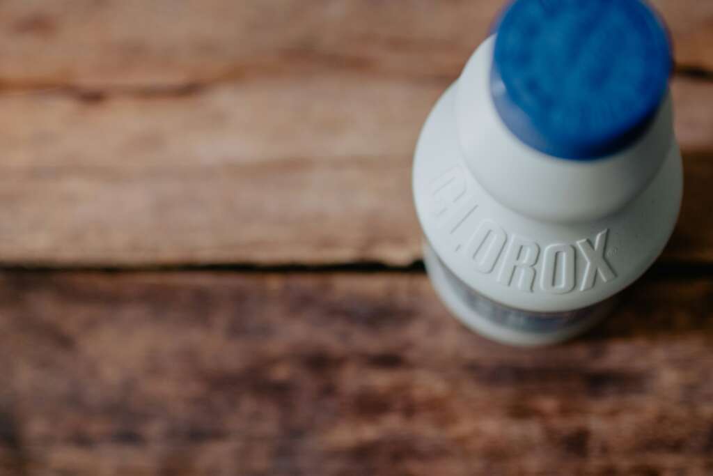 A bottle of Clorox on a table. 