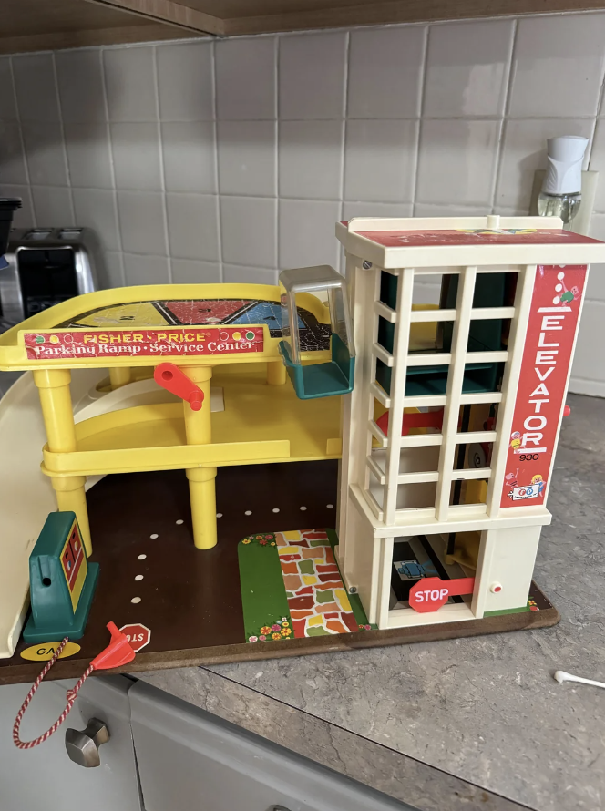 An image of a very cute Fisher-Price parking garage toy. 