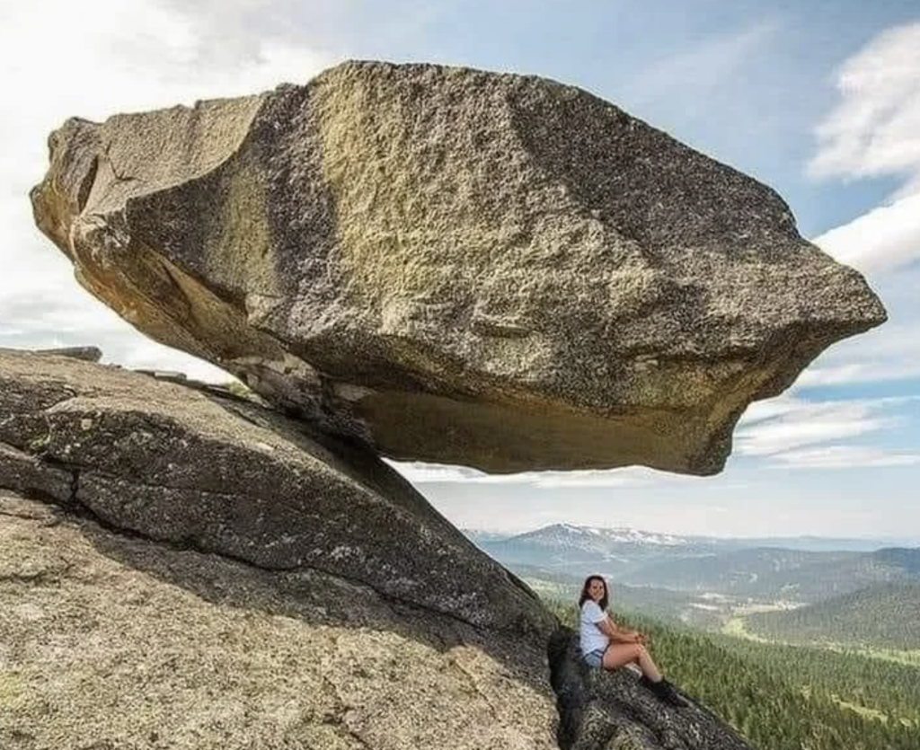 An image of a huge hanging stone in the Sayan mountains in Siberia. 