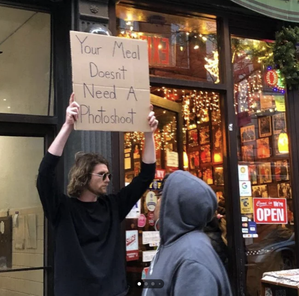 An image of someone holding up a cardboard sign. 