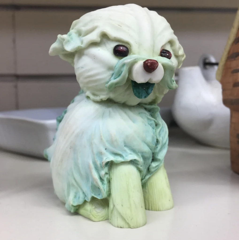 An image of a dog made out of cabbage. 