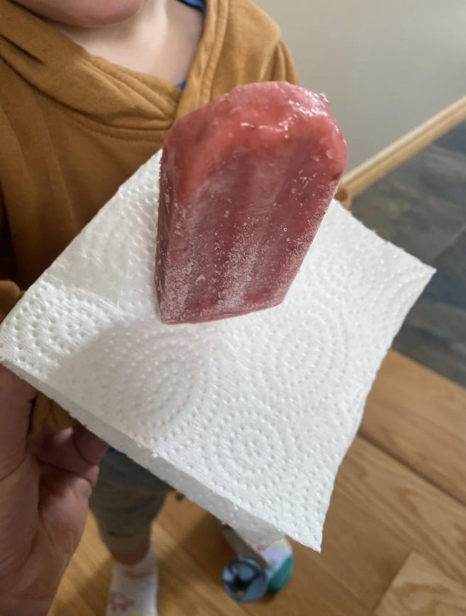 An image of someone's wife showing off a popsicle eating life hack. 