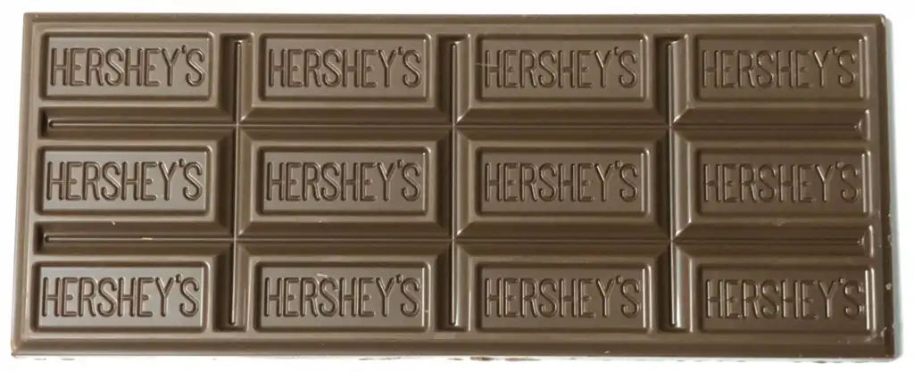 A Hershey's milk chocolate bar, consisting of twelve rectangular segments, each embossed with the Hershey's logo. The bar is unwrapped and displayed on a white background.