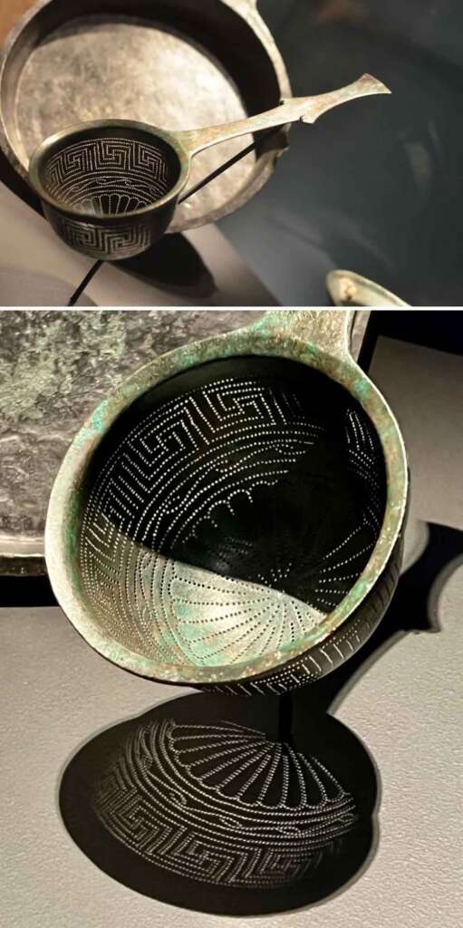 Two images of a historical bronze ladle. The first shows the ladle resting partially inside a bowl. The second image focuses on the ladle, highlighting its intricate perforated design, which casts a complex shadow pattern on the surface below.