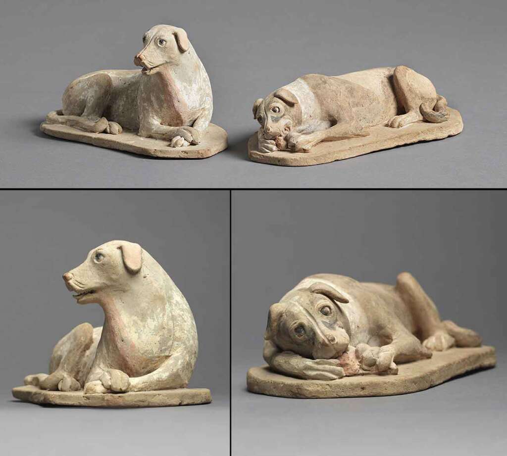 Four views of ancient terracotta dog statues are depicted. The statues, painted in earthy tones, show one dog lying down and another with its head up. The top view shows both dogs, while the bottom views focus on individual perspectives from different angles.