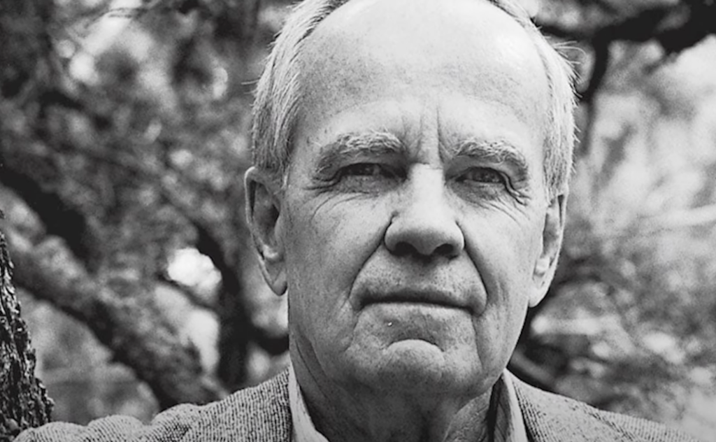A black and white close-up image of Cormac McCarthy. 