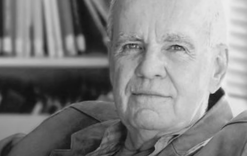 Close-up black and white image of Cormac McCarthy staring at the camera. 
