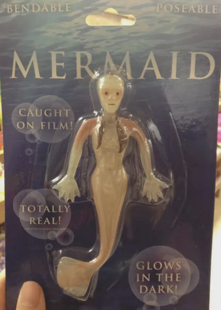 An image of a mermaid toy that looks like an alien. 