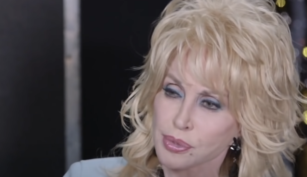 Close-up image of Dolly Parton being interviewed. 