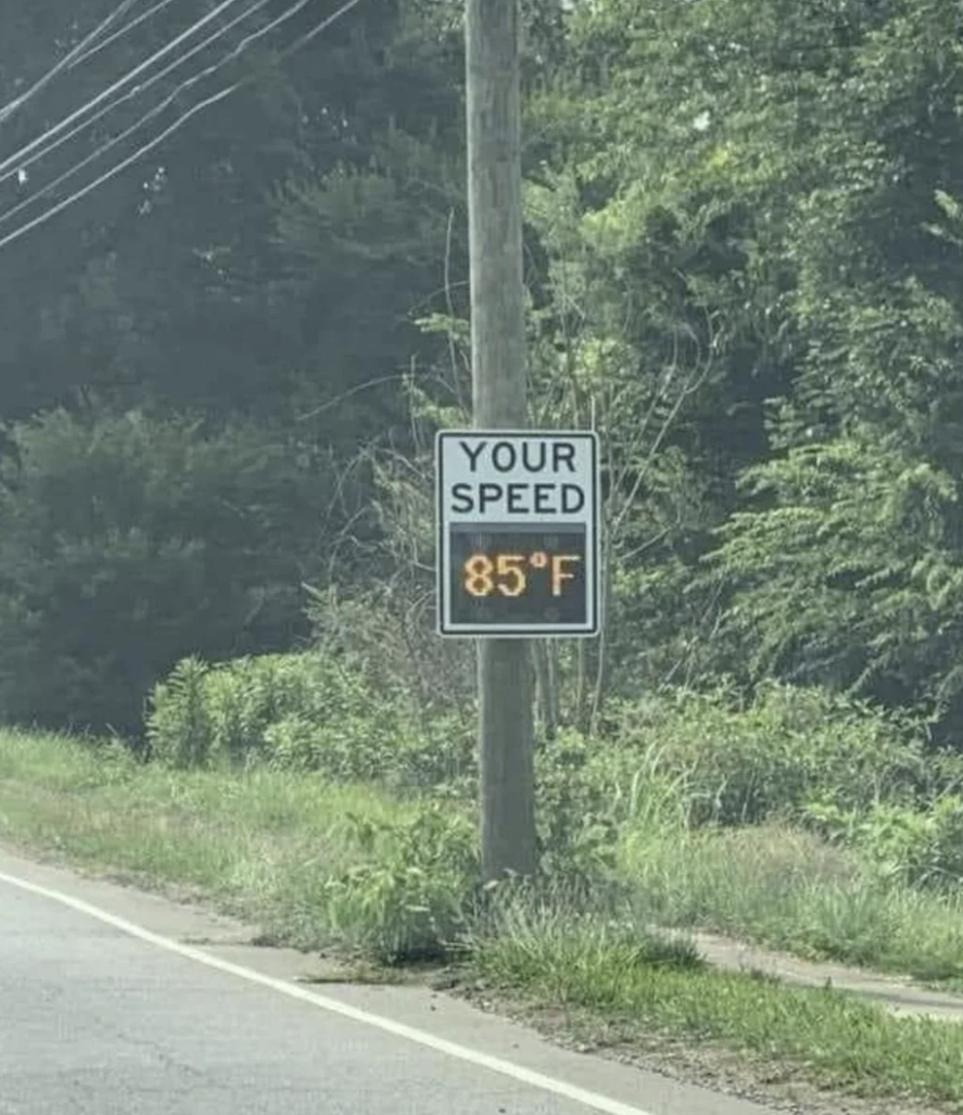 An image of a speed limit sign with a temperature reading. 