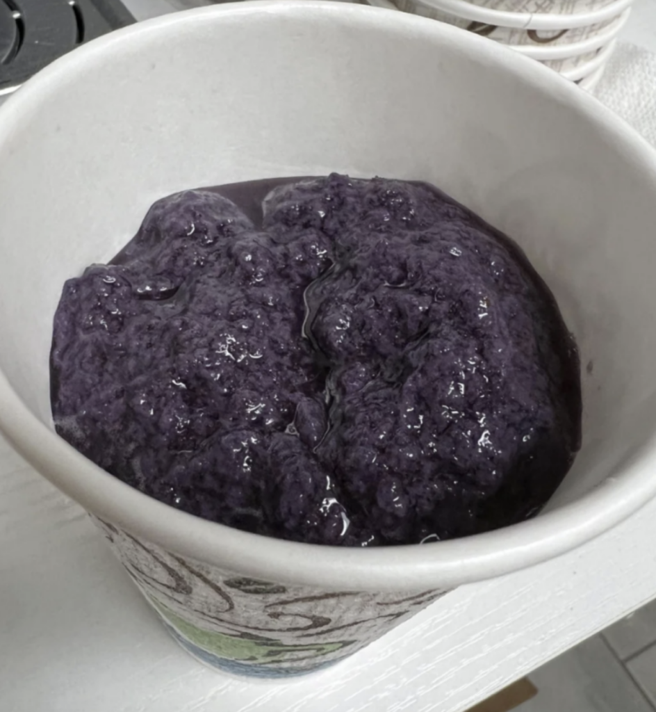 An image of a purple-colored smoothie. 