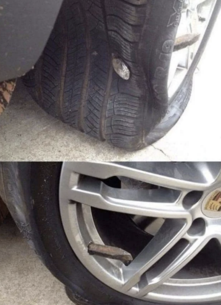 An image of a huge nail in a tire. 