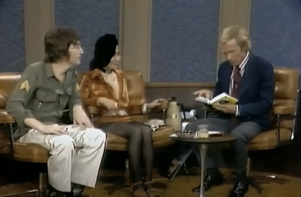 An image of John Lennon being interviewed. 