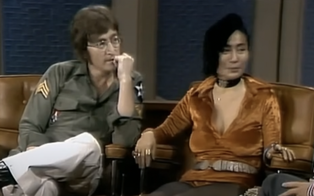 An image of John Lennon being interviewed. 