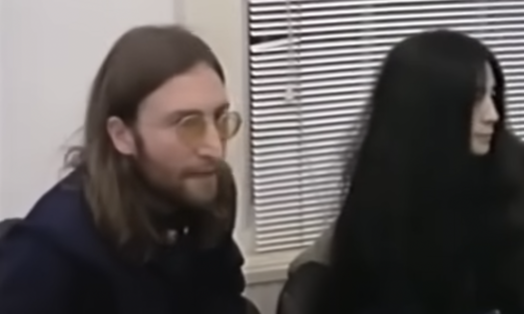 An image of John Lennon being interviewed. 