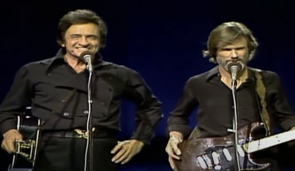 Johnny Cash smiling at the crowd. 