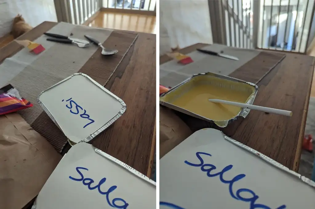 Two images side by side show a container of yellow sauce or spread on a wooden table. The left image features the container lid with a blue handwritten label. The right image displays the open container with a spoon inserted, and more table settings in the background.