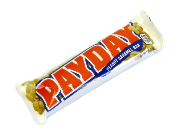 A Payday candy bar in its wrapper. The wrapper is primarily white with bold red and blue lettering that reads "PAYDAY" and "Peanut Caramel Bar." The bar is 52 grams and displays images of peanuts surrounding the text.