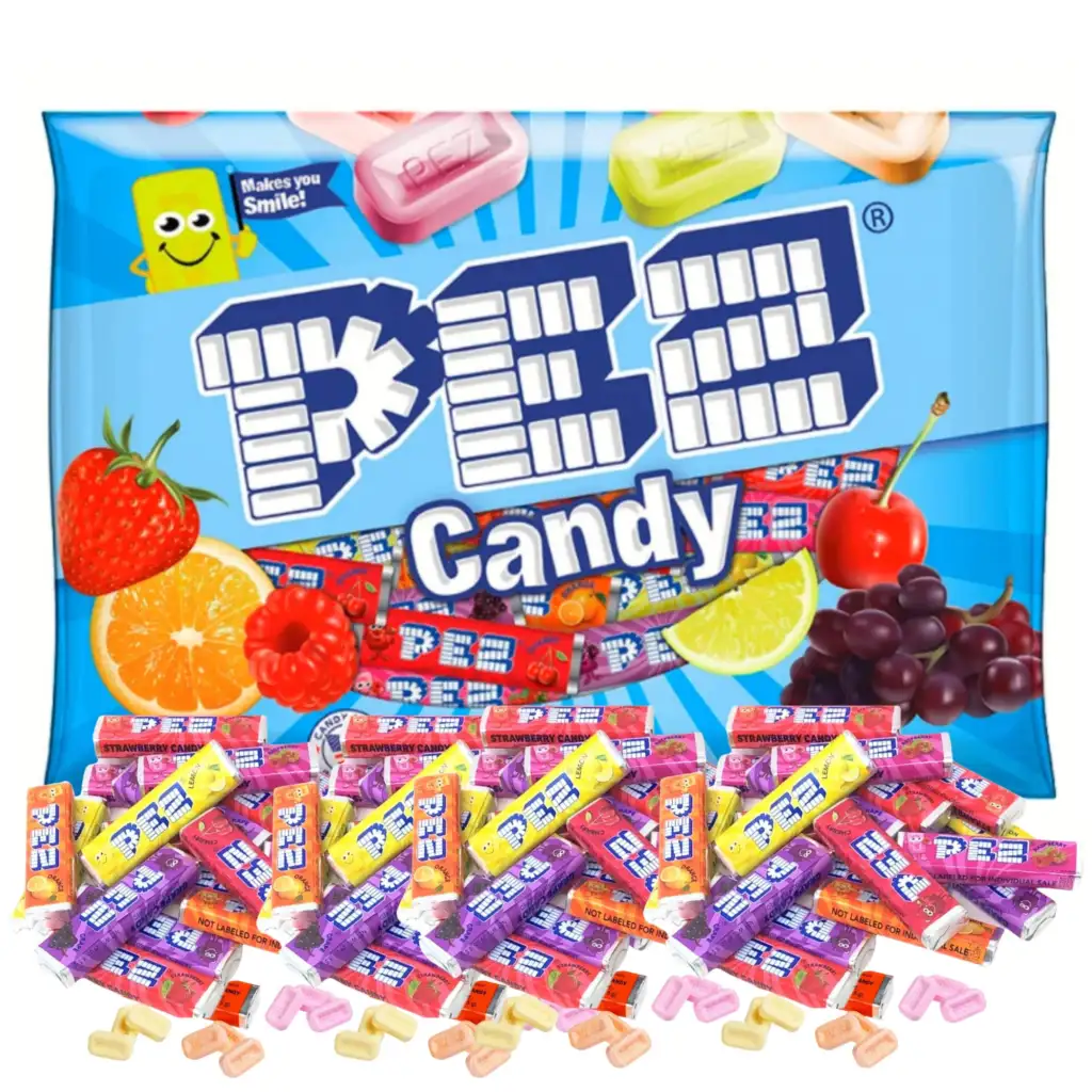 A pack of PEZ candy surrounded by various PEZ refill packs and loose candy pieces. The packaging features fruit illustrations, including strawberries, cherries, limes, and grapes. The slogan "It makes you Smile!" appears near a yellow smiling face icon.