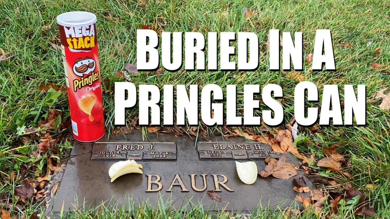 A tombstone with "Fred J." and "Elaine H." engraved on it is surrounded by grass and fallen leaves. On top of the tombstone are a Pringles can and some Pringles chips. Large white text over the image reads, "BURIED IN A PRINGLES CAN.