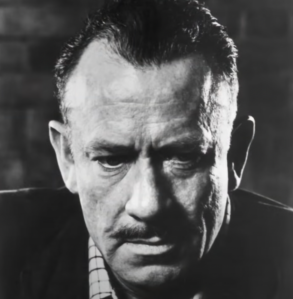 John Steinbeck older with mustache in a black and white portrait photo. 