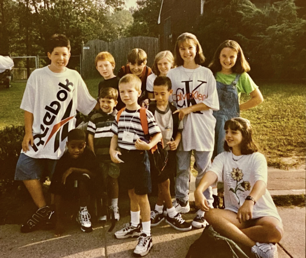 An image of a crew of kids at a bus stop in the '90s. 