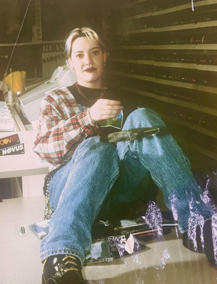 An image of someone when they worked at a record shop when younger in the late 1990s. 