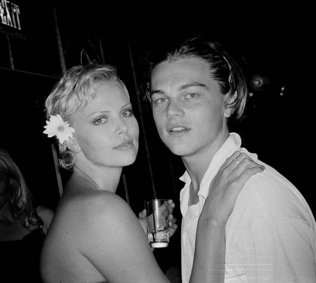 An image of a young Leo DiCaprio next to Charlize Theron at her 22nd birthday party.