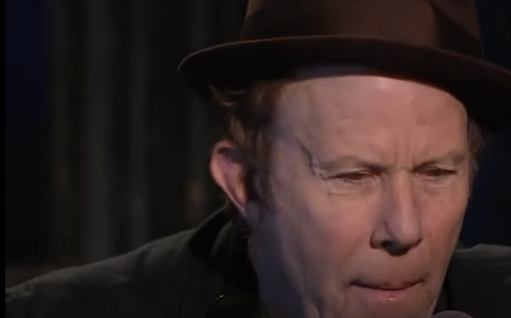 Tom Waits performing in a nice hat. 