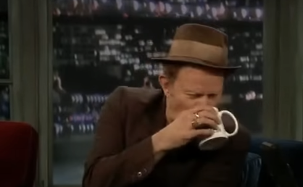 Tom Waits drinking coffee on talk show. 