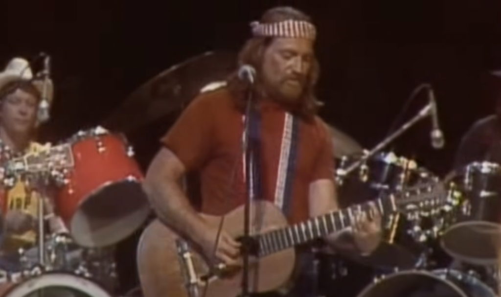 An image of a young Willie Nelson in a bandana. 